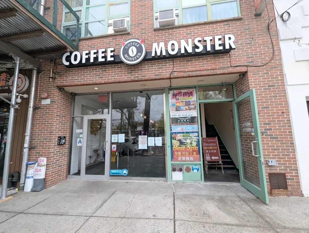 Coffee Monster storefront on 41st Ave: brick facade with the Coffee Monster sign over glass doors